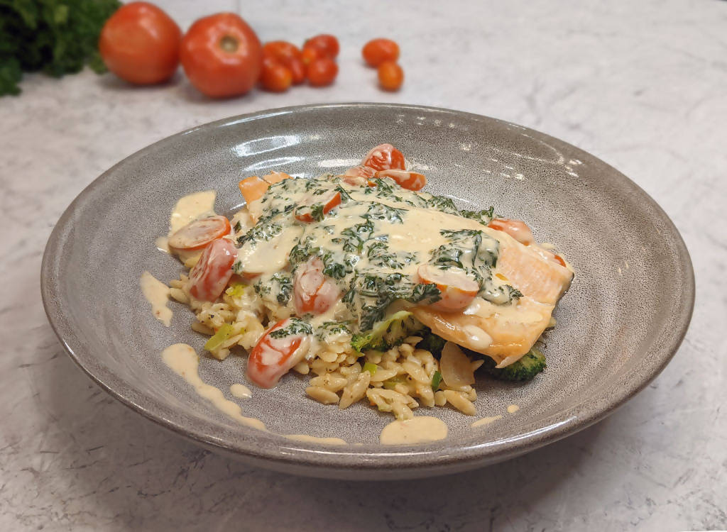 Pan-fried rainbow trout in a florentine sauce with cherry tomatoes